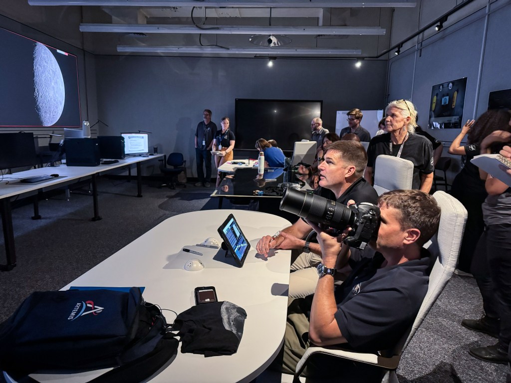 NASA astronaut and Artemis II commander, Reid Wiseman (foreground), and CSA (Canadian Space Agency) astronaut and Artemis II mission specialist, practice lunar photography at NASA's Johnson Space Center in Houston. The Artemis II crew will be the first people in more than 50 years to set eyes on the far side of the Moon, depending on illumination conditions. They will document their observations through photographs, audio recordings, and more to inform our understanding of the Moon, and share their experience of being far from Earth. (NASA/Kelsey Young)