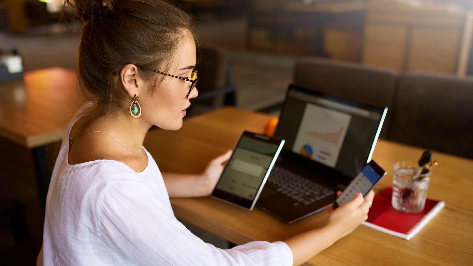 Busy Millennial uses mutliple screen devices showing source of stress
