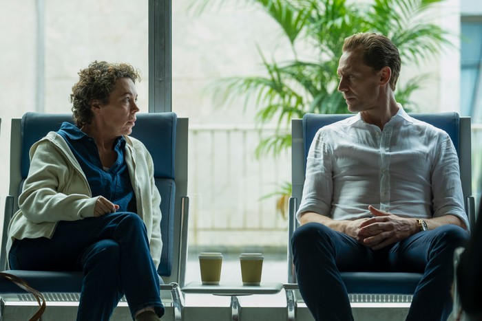 546202,TITLE: The Night Manager S2 Olivia Colman and Tom Hiddleston star in The Night Manager season 2; in this scene, Angela and Pine are sat next to each other in an airport waiting area, having a serious conversation