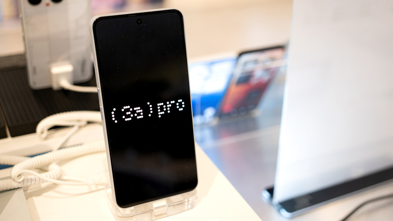 A Nothing Phone (3a) Pro mounted on a display stand.