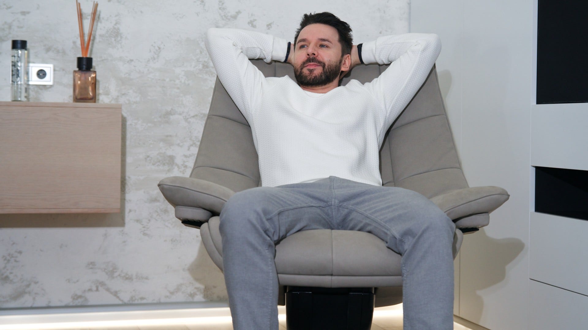man in a comfortable chair who keeps photo albums