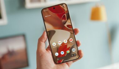 Image of a hand holding a phone with the screen turned on.