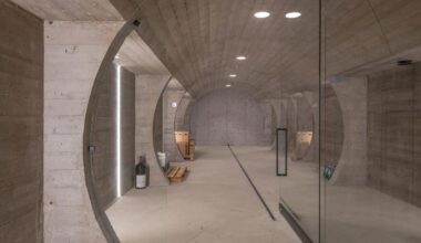 barrel-vaulted concrete cellar organizes vineyard building in poland