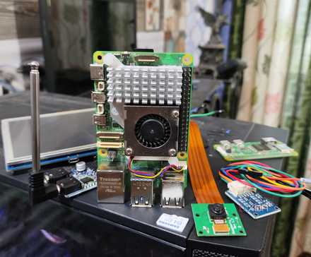 The Raspberry Pi 5 and its accessories lying on top of a PC