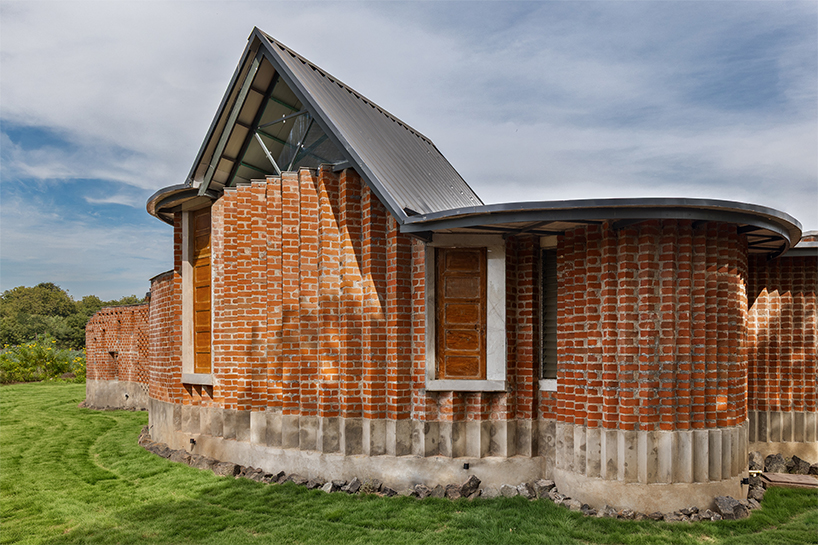 curved brick patterned walls frame farmhouse by manoj patel in india