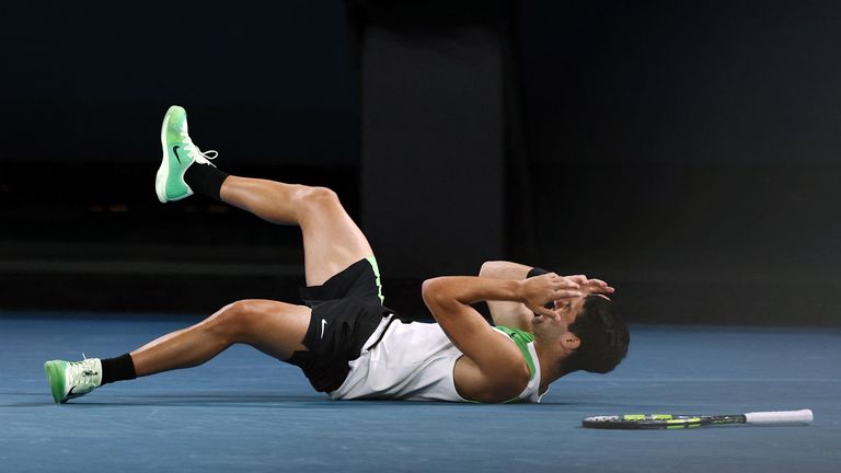 Alcaraz collapses to the floor after winning the final set. Pic: Reuters