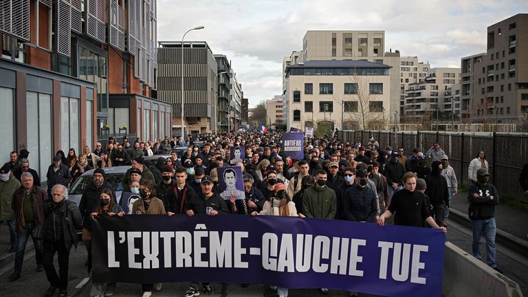 People hold a banner that says 'the far-left kills'. Pic: AP