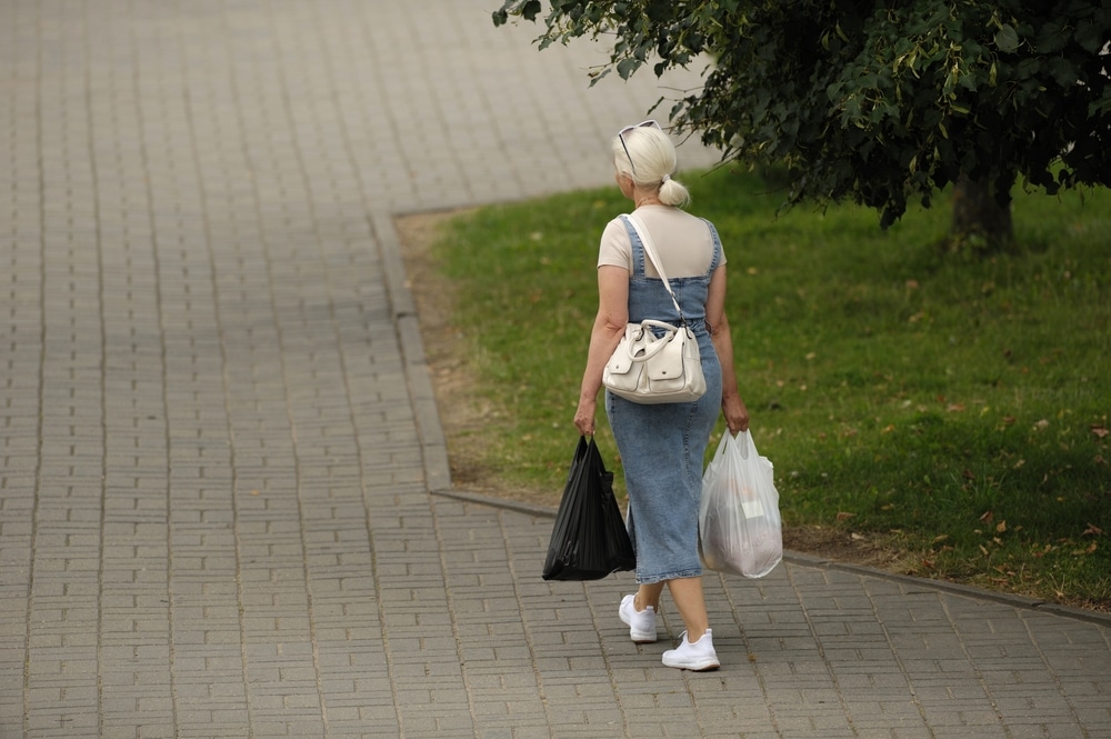 The Exercise Involves Walking While Holding A Heavy Load In Each Hand