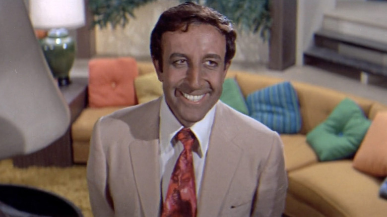 Hrundi V. Bakshi smiling in a living room in The Party