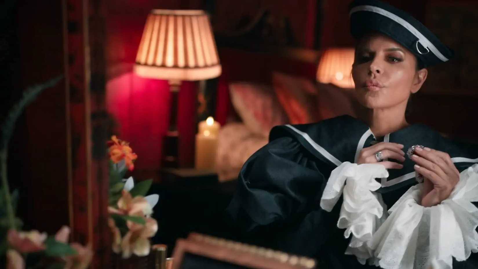 The Traitors Season 4's Lisa Rinna Putting on Amulet In Mirror