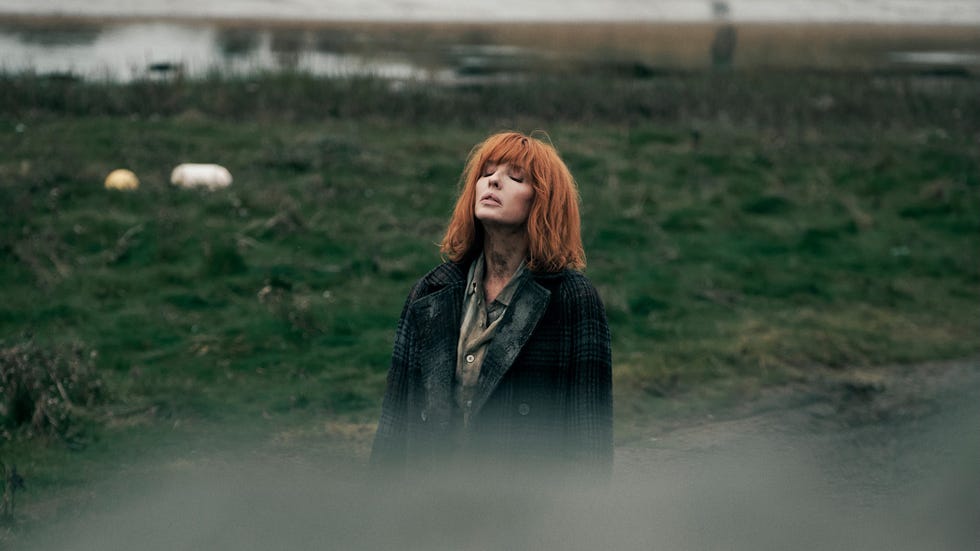 under salt marsh kelly reilly with her eyes closed, lifting her head to the sky