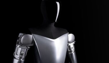 A robot in front a of a black background.