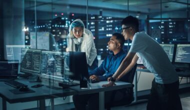 AI engineers gathered around a computer.