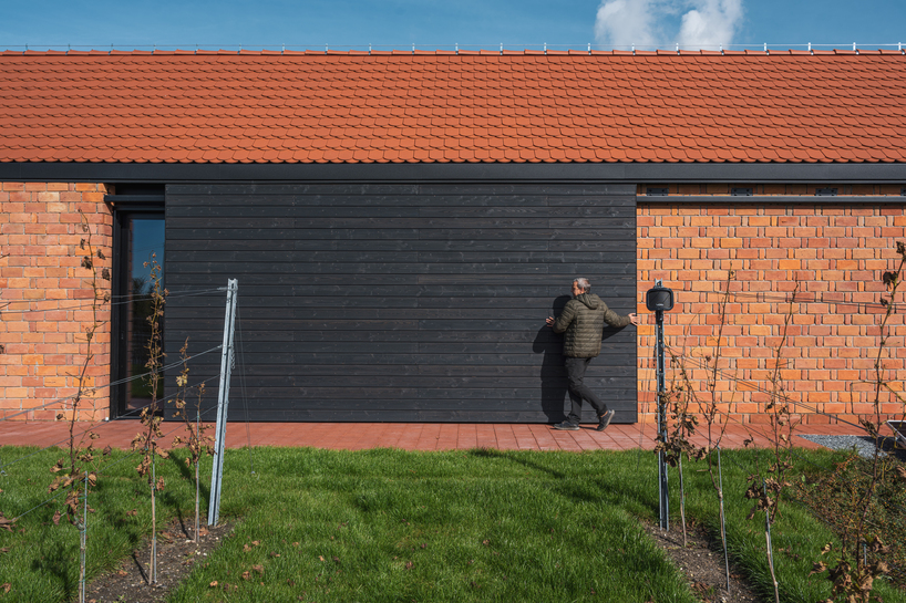barrel-vaulted concrete cellar organizes vineyard building in poland