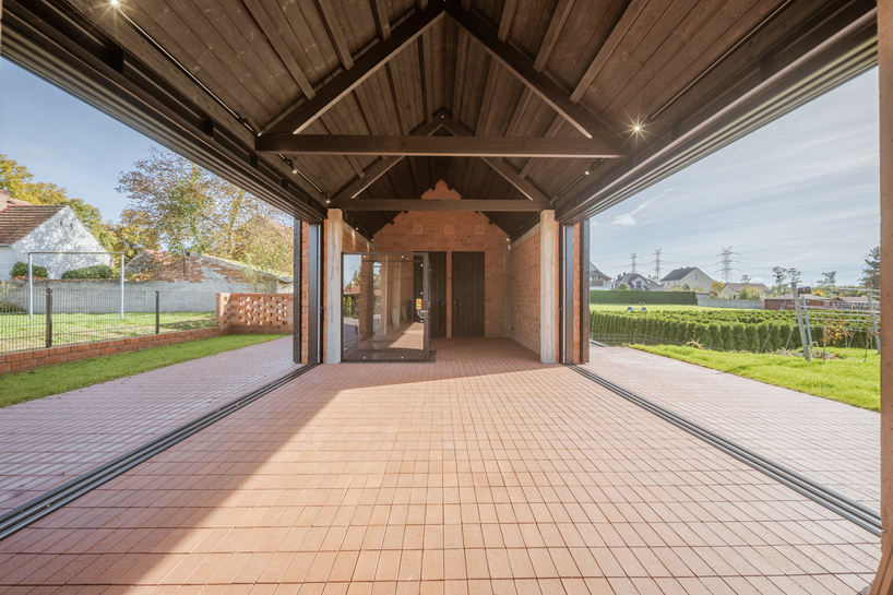 barrel-vaulted concrete cellar organizes vineyard building in poland