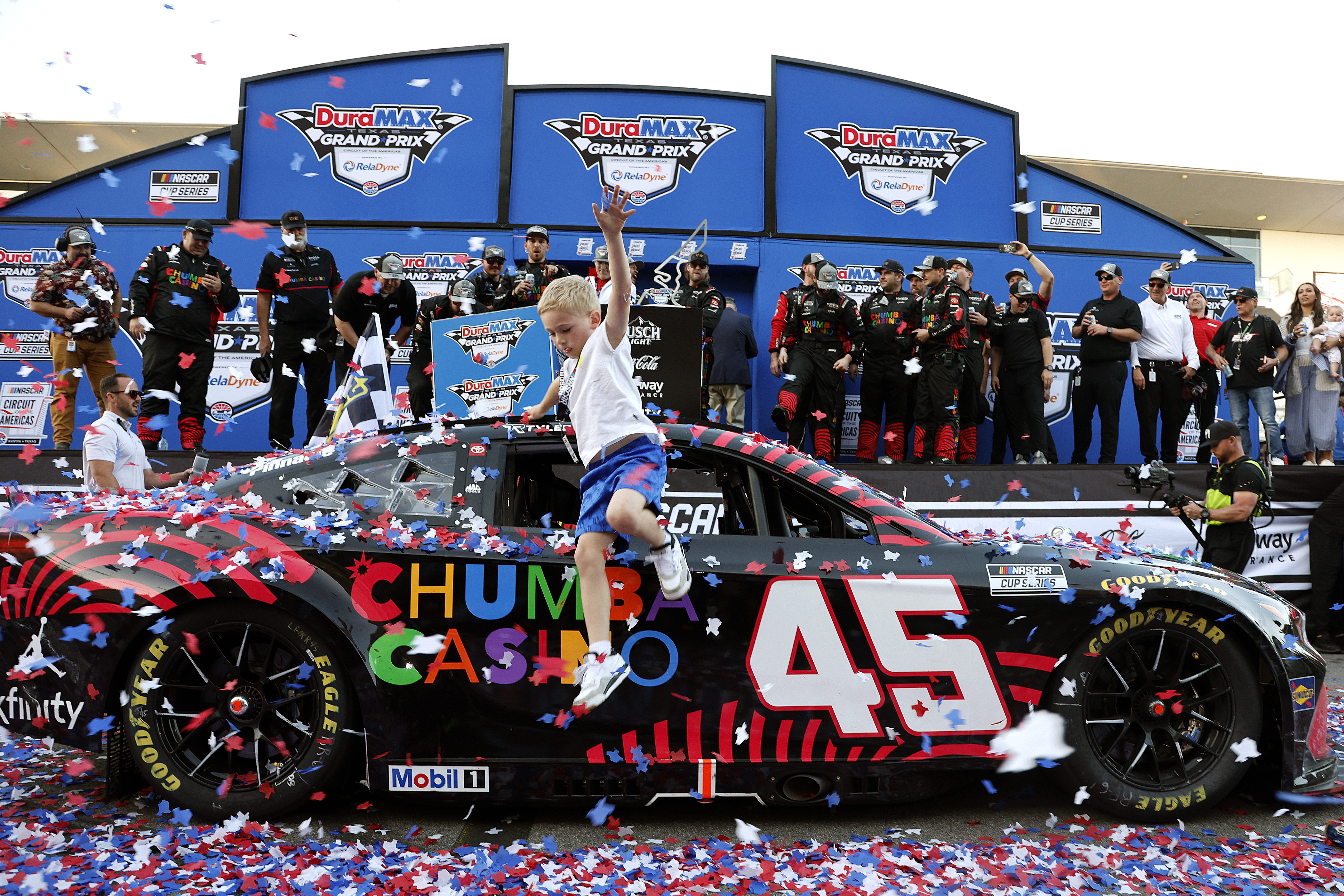 Beau Reddick, son of Tyler Reddick, leaps from the #45 Chumba Casino Toyota in victory lane.