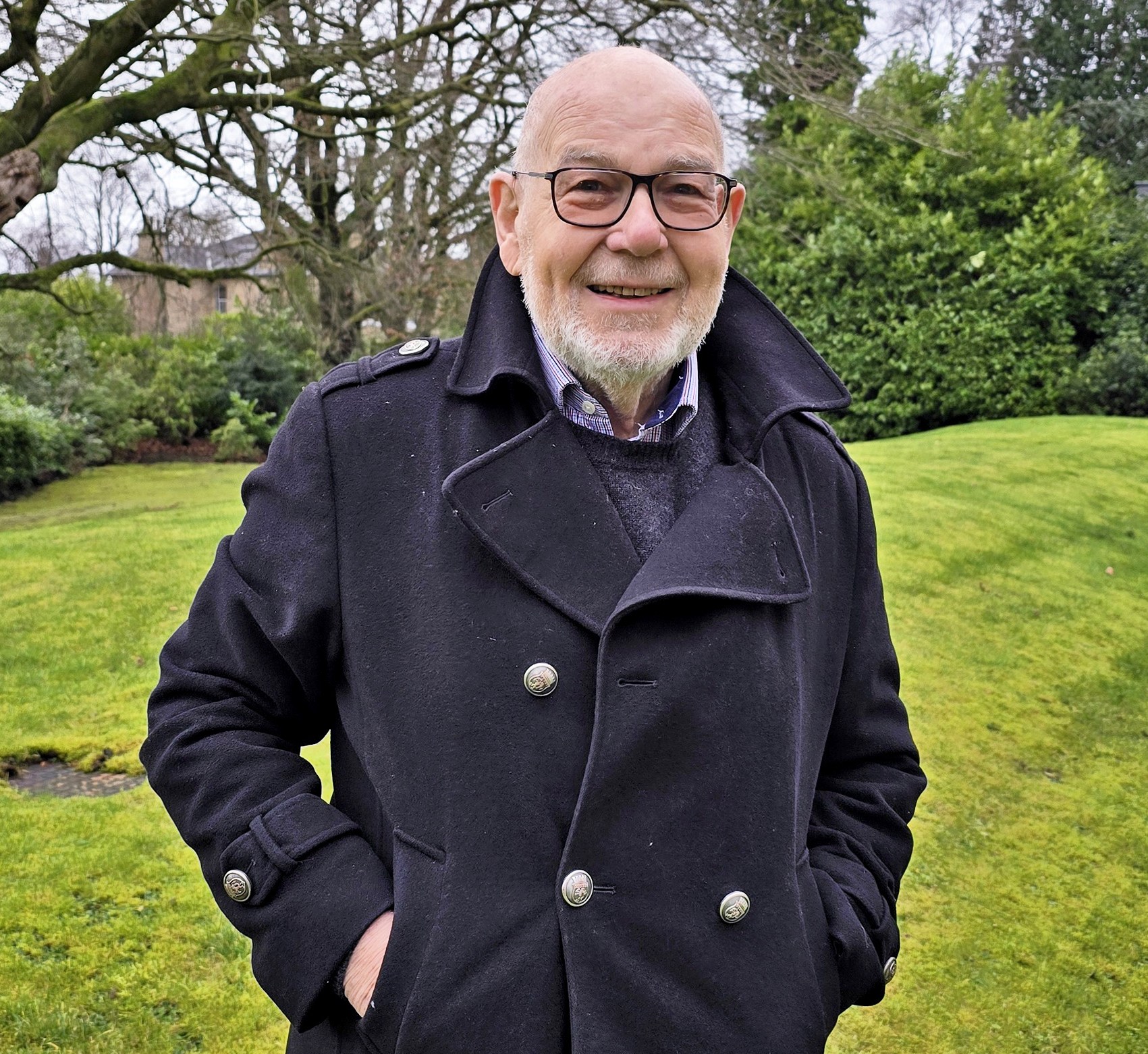 Jonathan Edwards, a retired solicitor, smiling at the camera outdoors.