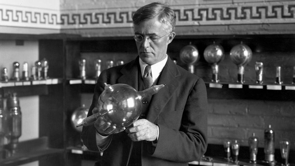 In a 1930 portrait, GE chemist Dr. Irving Langmuir holds a pliotron, a type of vacuum tube he helped to invent in 1912-1913. The tube was used in 1914 as a current amplification device for radio and telephone communications; it was succeeded by smaller, more efficient tubes that still operated on the principles developed in Langmuir's research. (Photo by Schenectady Museum; Hall of Electrical History Foundation/CORBIS/Corbis via Getty Images)