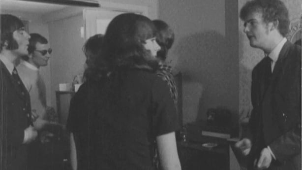 Black and white photo of young people in 1971 chatting