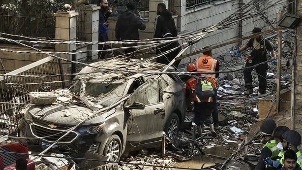 First responders work at a site of an Israeli strike on the southern suburbs of Beirut 