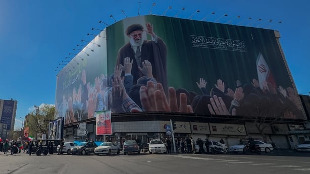 A billboard depicting Iran's slain Supreme Leader Ayatollah Ali Khamenei is displayed in the centre of Tehran's Enghelab Square