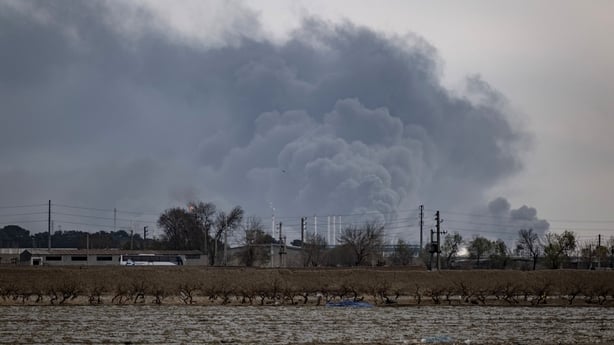 The sky is darkened by oil-soot residue from Tehran's petroleum storage facilities after it was struck during a US-Israeli military campaign.