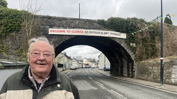 Berti McMahon standing in front of a welcome sign ahead of the St Patrick's Day parade in Clara