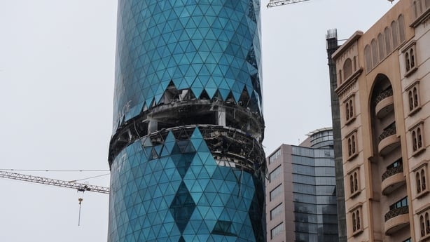 A photograph shows a damaged building in the aftermath of a drone strike in the Seef district of Manama on March 10, 2026. The oil-rich Gulf has borne the brunt of Iran's attacks in response to US-Israeli strikes that sparked the Middle East war, with Tehran targeting US assets but also civilian inf