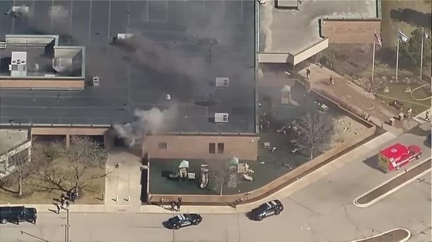 Aerial shot of a building that has smoke coming out of it