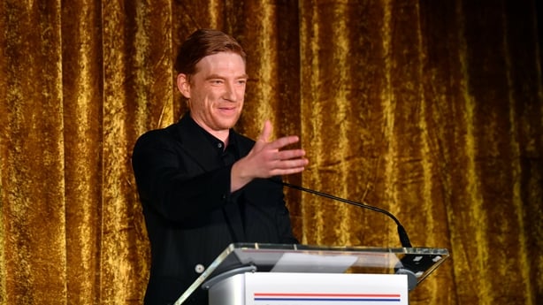 Domhnall Gleeson accepts an award onstage during the US-Ireland Alliance's 20th annual Oscar Wilde Awards