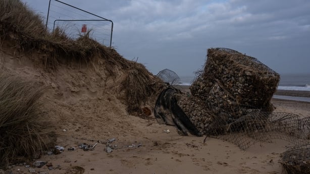 HEMSBY, ENGLAND - JANUARY 19: A coastal gabion lies in the sand after falling from a dune in an area affected by rapid coastal erosion on January 19, 2026 in Hemsby, England. Recent bad weather, including Storm Goretti has seen almost 10 metres of land lost to coastal erosion in Hemsby, with a numbe