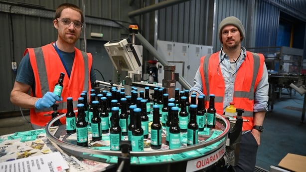 ELLON, SCOTLAND - APRIL 03: Martin Dickie and James Watt from BrewDog brewery pack hand sanitizer being produced at the plant on April 03, 2020 in Ellon, Scotland. Scotland based brewery BrewDog have adapted their production to develop and produce hand sanitizer to donate to various charities across