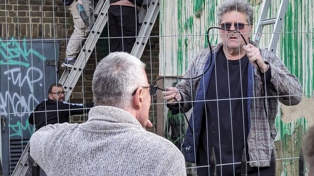 A man believed to be Robin Gunningham at the scene of a Banksy mural in London in March 2024