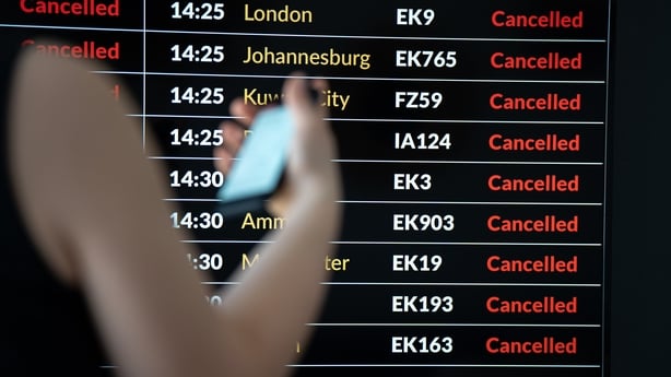 A female passenger checks her flight status on the airport arrivals and departures board in Krakow, Poland, on March 5, 2026. The table shows a list of canceled flights as global air travel faces chaos following military strikes by the United States and Israel against Iran. Airlines suspend thousand