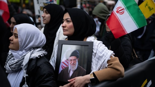 NEW YORK, NEW YORK - MARCH 13: A person holds an image of Ayatollah Ali Khamenei, as others hold Iranian flags, during a rally for Al Quds Day on March 13, 2026 in New York City. People gathered around the world for Al Quds Day, also known as Jerusalem Day, amidst the ongoing war between the US, Isr