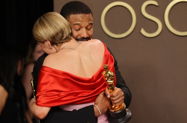 HOLLYWOOD, CALIFORNIA - MARCH 15: (L-R) Jessie Buckley, winner of the Best Actress Award for “Hamnet” and Michael B. Jordan, winner of the Best Actor Award for “Sinners”, embrace in the press room during the 98th Oscars at Dolby Theatre on March 15, 2026