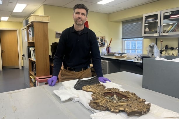 Matt Seaver standing alongside a reliquary