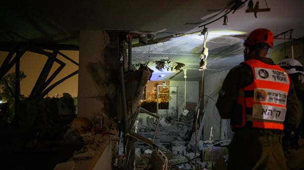 TEL AVIV, ISRAEL - MARCH 19: Civil defense workers, and engineers survey damage, including a hole in the roof created from an Iranian Ballistic missile striking the building just before midnight on March 19, 2026 in the Ramat Aviv neighborhood of Tel Aviv, Israel. Iran has continued firing waves of 