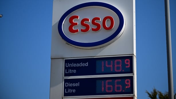 Petrol and diesel pump prices are displayed on a sign at an Esso petrol station