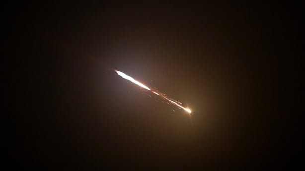 Missiles launched from Iran towards Israel are seen in the sky over Hebron