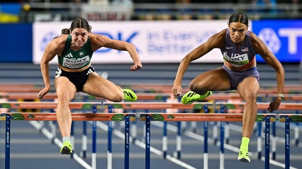 22 March 2026; Kate O'Connor of Ireland, left, and Anna Hall of United States compete in the Women's 60m hurdles event in the Women's Pentathlon during day three of the World Athletics Indoor Championships at Kujawsko-Pomorska Arena in Torun, Poland. Photo by Sam Barnes/Sportsfile