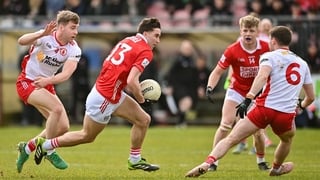 22 March 2026; Chris Og Jones of Cork in action against Cormac Quinn and Niall Devlin of Tyrone during the Allianz Football League Division 2 match between Tyrone and Cork at O'Neills Healy Park in Omagh, Tyrone. Photo by Oliver McVeigh/Sportsfile