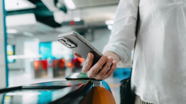 Close-up shot a person making a contactless payment with smartphone