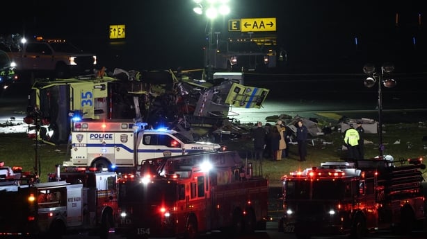 Emergency personnel respond to the Port Authority fire truck that was struck by a landing Air Canada Express plane