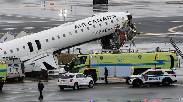 An Air Canada Express CRJ-900 sits on the runway after colliding with a Port Authority fire truck at LaGuardia Airport on March 23, 2026 in New York City