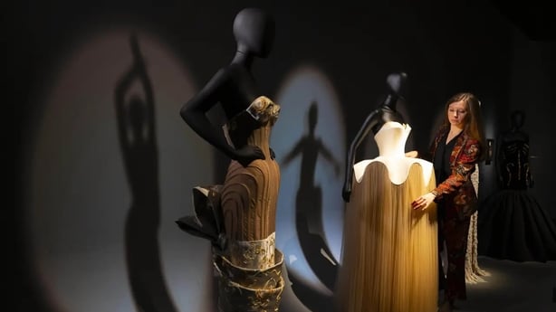 A SS 2025 haute couture gown worn by Kendall Jenner (left) and a custom haute couture gown worn by Ariana Grande to the 2025 Oscars on display at the V&A (David Parry/PA)
