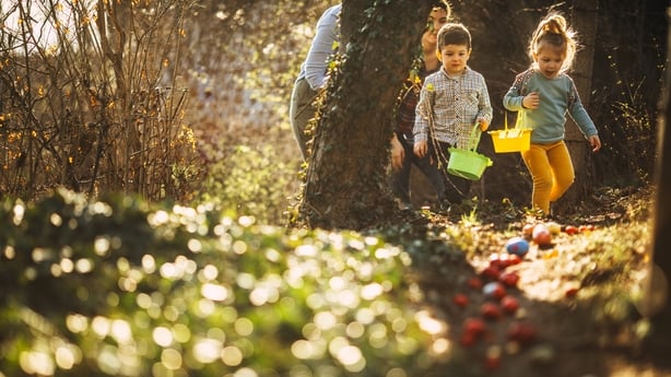 Cute little kids and their moms during Easter egg hunt