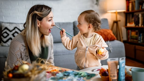 Mother and daughter coloring Easter eggs