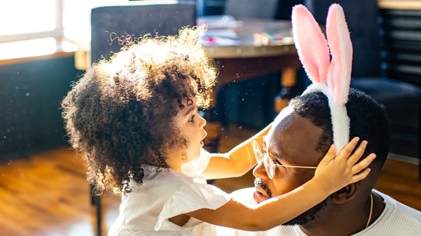 father and child wearing easter bunny ears 