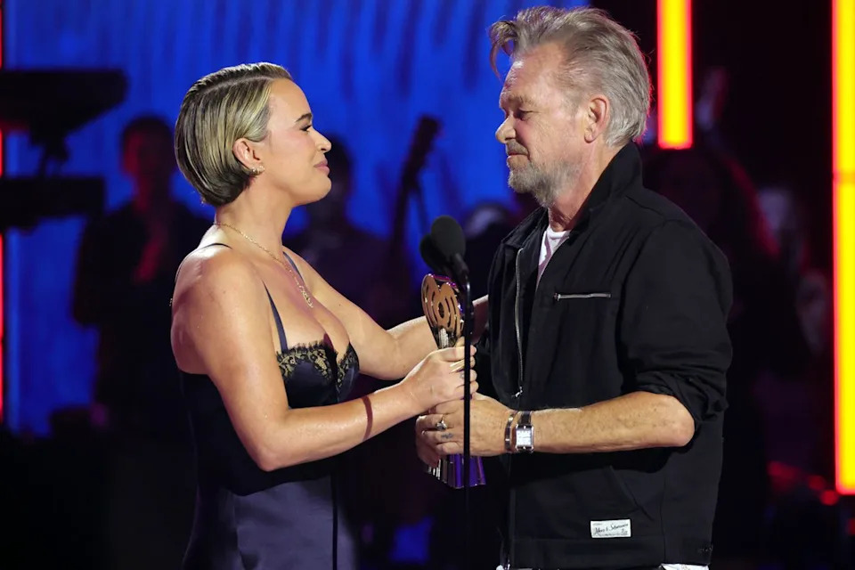 Teddi Mellencamp presents father John Mellencamp with the iHeartRadio Icon AwardCredit: Kevin Mazur/Getty